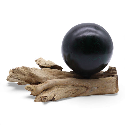 Unlit dark green crackle sphere shown on the driftwood lamp base against a white background