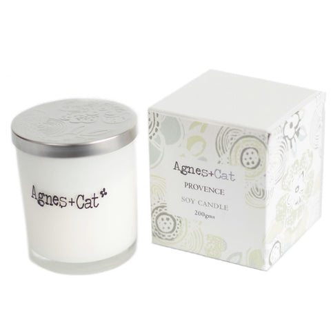 Agnes + Cat Votive Candle, Provence, white glass candle with silver lid beside its patterned box