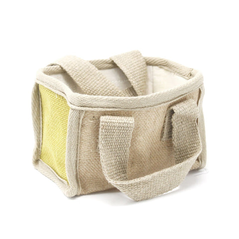 Close-up of the mini basket with yellow-green side panel, open top and woven handles on white