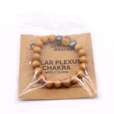 Cedarwood Solar Plexus Chakra Bangle with Citrine in a clear plastic sleeve on a printed card