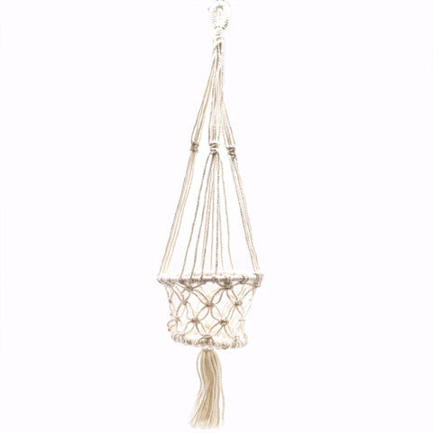 Full view of the empty cream macrame pot holder against a plain white background