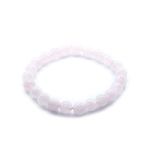 Rose quartz bracelet arranged in an oval on a plain white background, with pale pink round beads