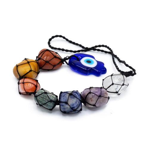 Hansa chakra stone pendant laid out on a white background, showing the coloured stones and blue eye charm