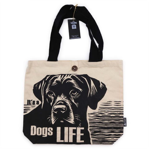Classic tote bag shown from the front, with black handles, a dog print and tag attached