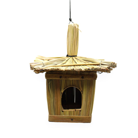 Small square seagrass bird box with a thatched roof, front view on a white background