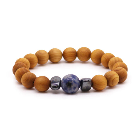Cedarwood Throat Chakra Bangle with Sodalite, round amber beads and blue stones in a front view