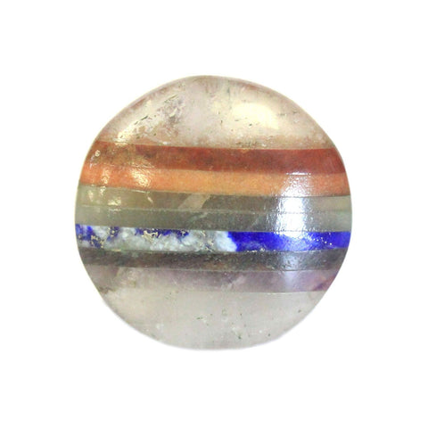 Bonded chakra palm stone held between finger and thumb