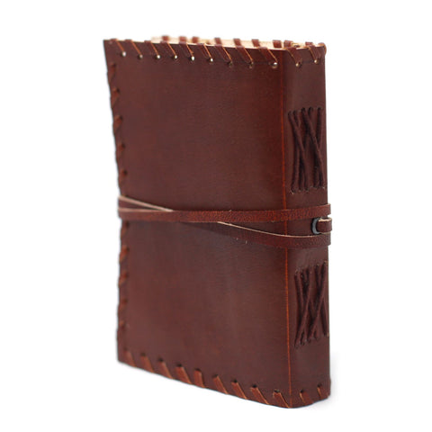 Leather Book of Thoughts with Wrap Notebook, brown stitched cover shown at an angle with wrap fastened
