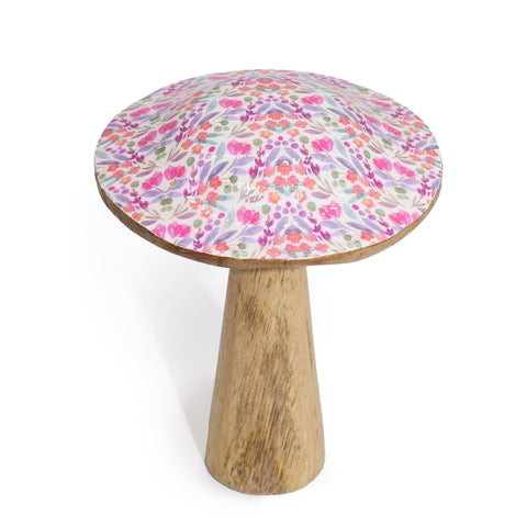 Pretty floral mushroom standing alone on a white background, showing its patterned top and wooden stem