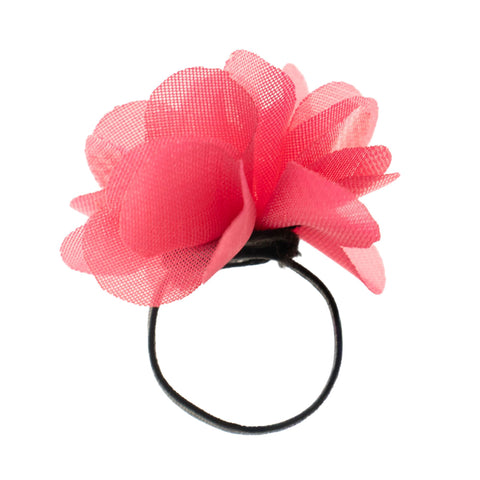 Pink diffuser ring and fragrance bottles beside a bowl of matching pink fabric flowers