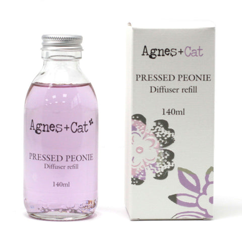 Agnes + Cat Reed Diffuser Refill, Pressed Peonies, pale pink liquid bottle beside its floral box