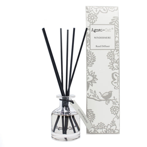 140ml Reed Diffuser, Windermere in a clear glass bottle with black reeds beside a grey floral box