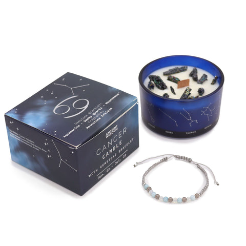 Cancer candle and closed gift box standing together with the gemstone bracelet in front