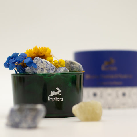 Sodalite and dried flower vessel with yellow and blue flowers, box blurred behind