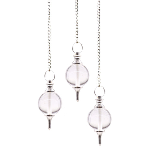 Sphere Pendulums, Rock Quartz, three clear spherical pendulums hanging from silver chains on a white background