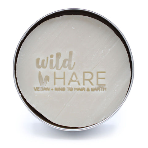 Wild Hare Solid Shampoo 60g, Hairy Coconut, round white bar with logo in a close-up view
