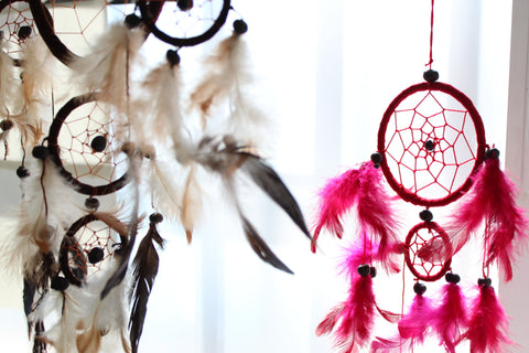 Bali Dreamcatchers, Small Round, Turq/Pink/Purp hanging in pink, with a larger white and black catcher beside it