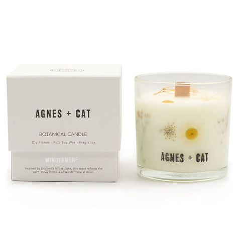 Windermere candle beside its white labelled box, showing pale wax and dried flowers in a glass jar