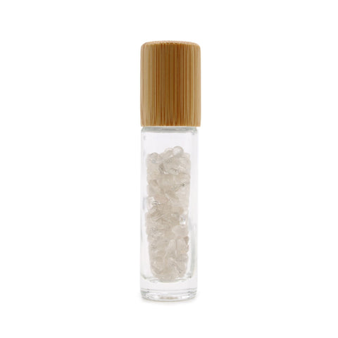 Rock quartz gemstone roller bottle with a wooden cap fitted, shown upright against a white background