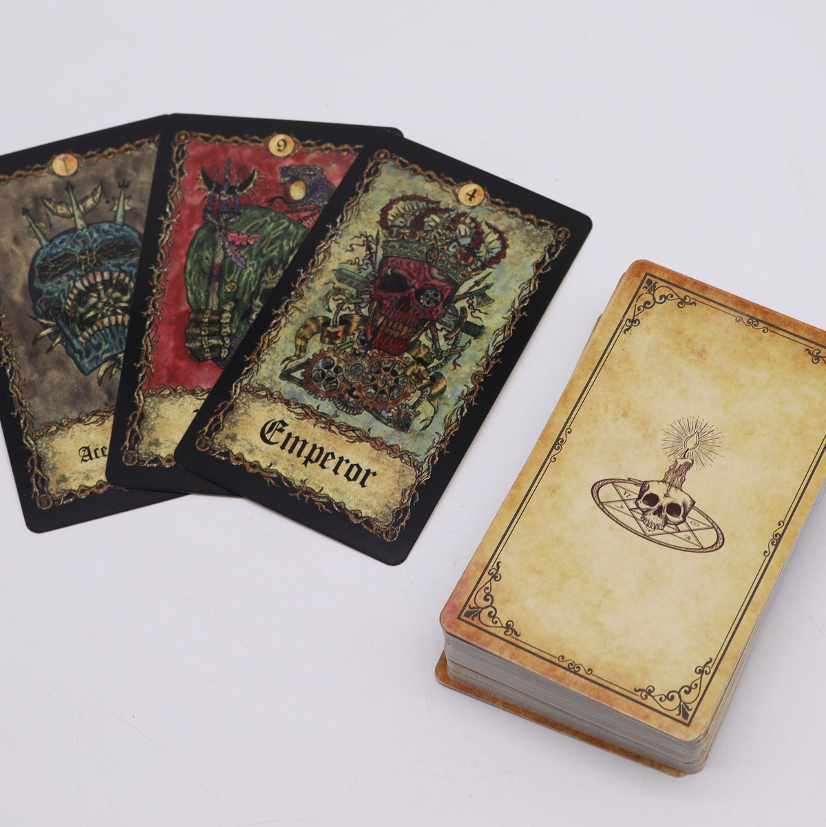 Three tarot cards fanned out beside a stacked deck on a white background.