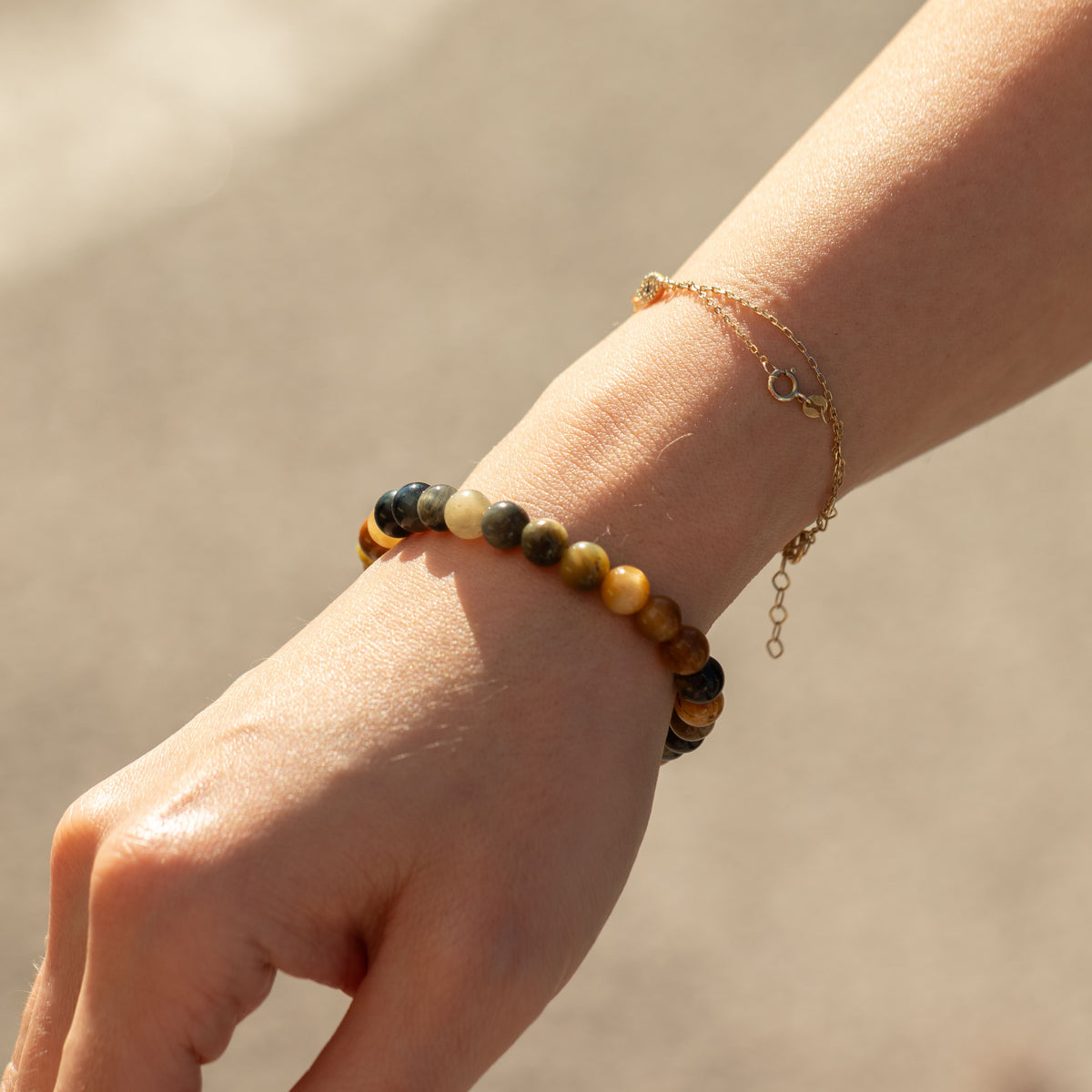 Dream Tigereye bracelet worn beside a gold bracelet