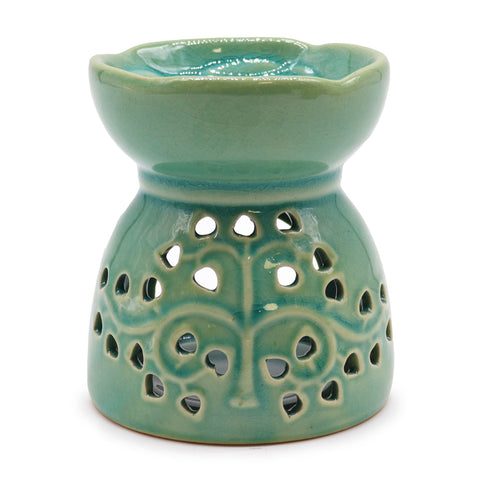 Blue-green Tree of Life oil burner shown from the front, with pierced tree pattern and open top