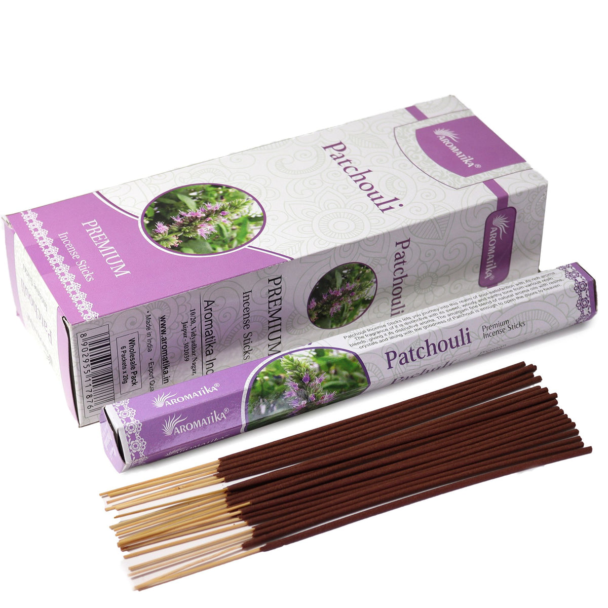Patchouli incense in a white and purple box and sleeve, with brown sticks and pale ends laid out
