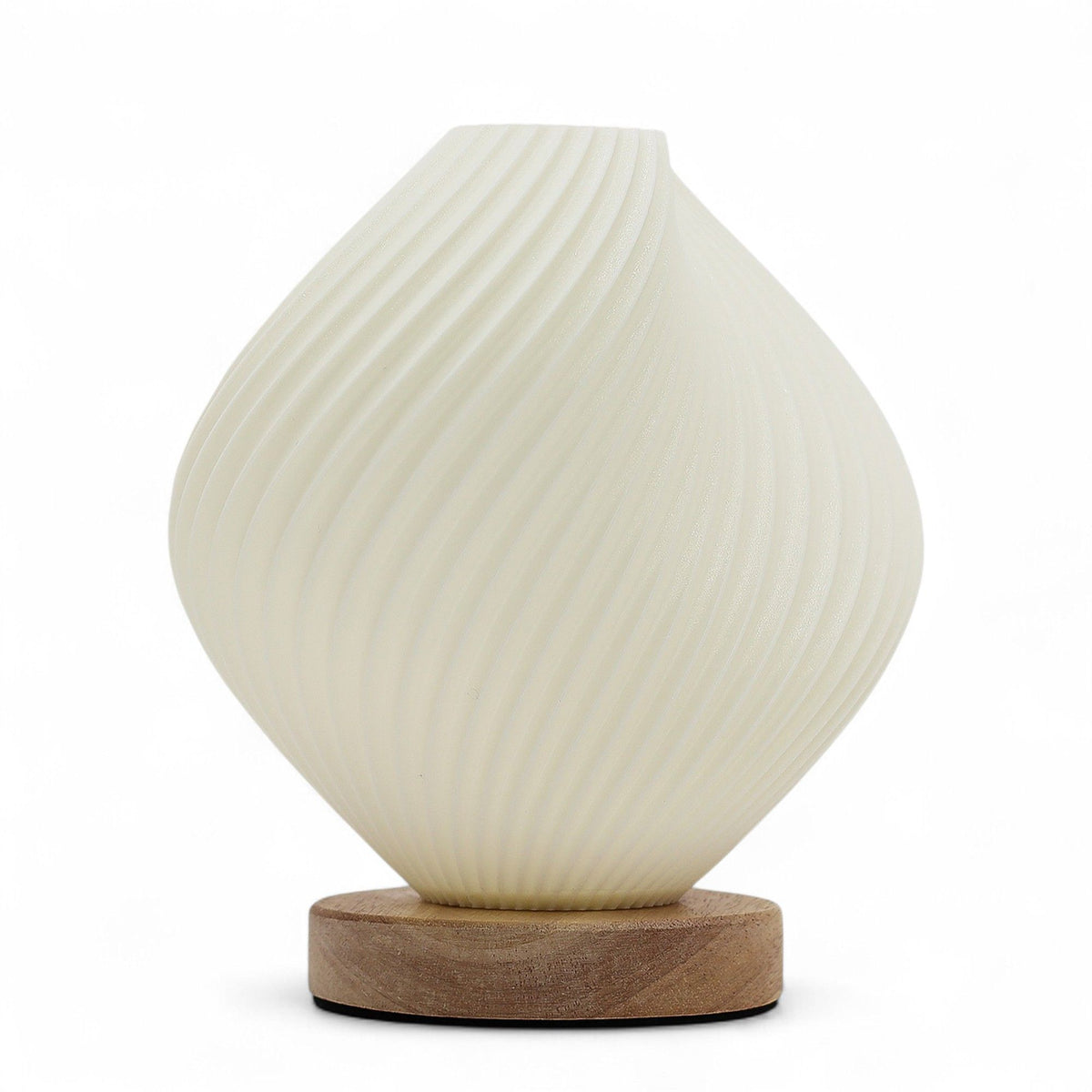 Front view of the cream twisted lamp glowing against a white background on its wooden base