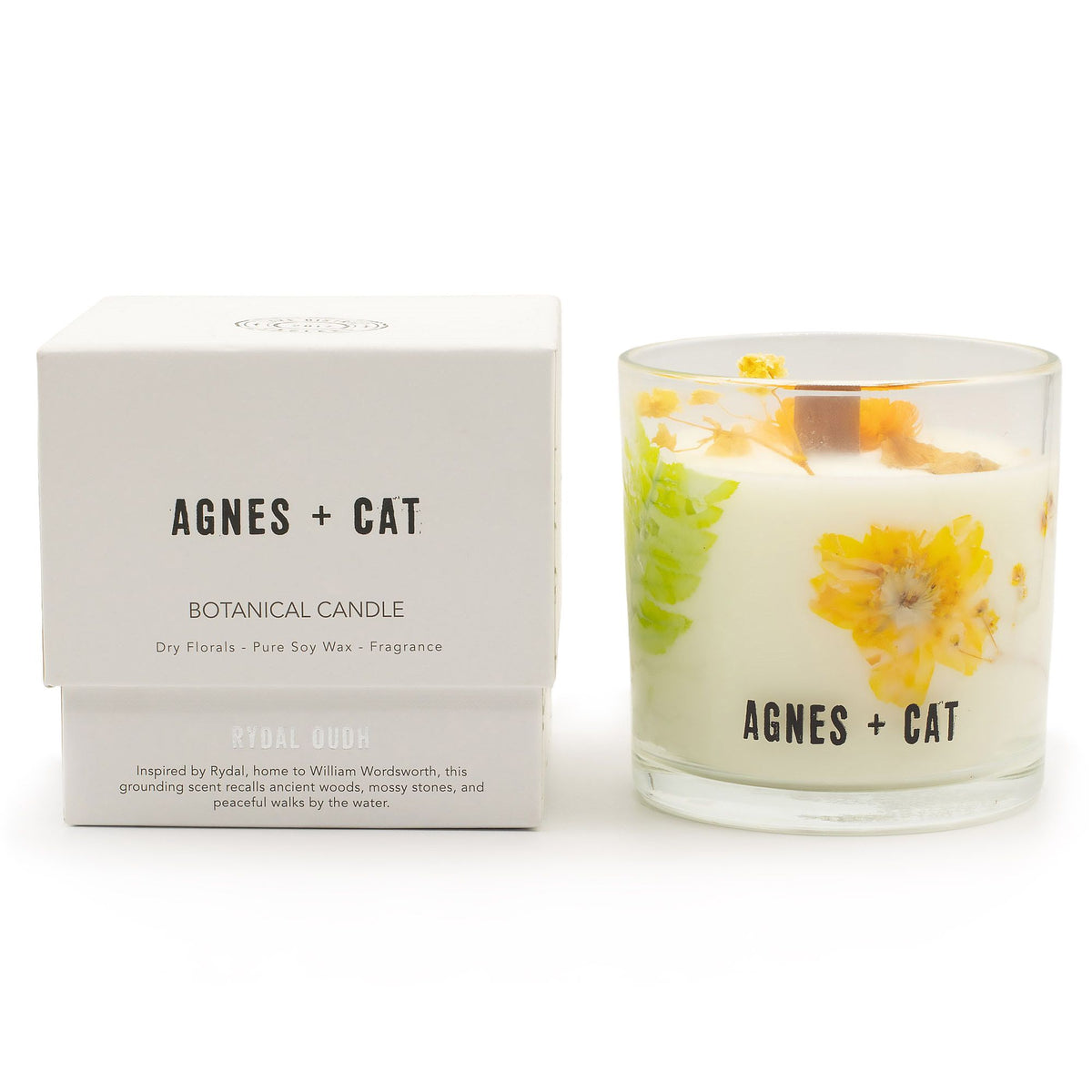 Rydal Oudh candle beside its white box, showing the yellow botanical decoration and front label