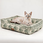 Green Lucky Elephant pet bed with a cat resting inside