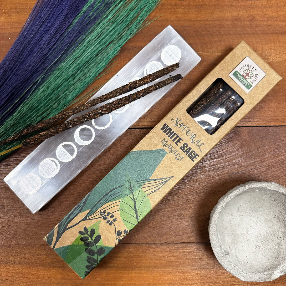 Natural Botanical White Sage incense box open beside two loose sticks and dried flowers