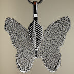 Close-up of a silver-coloured butterfly pendant