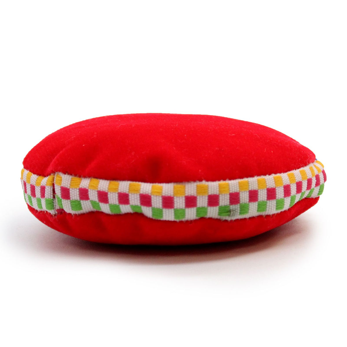 Red Singing Bowl Velvet Cushion shown from the side, with a multicoloured checked trim
