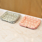 Green and orange patterned pet beds shown side by side