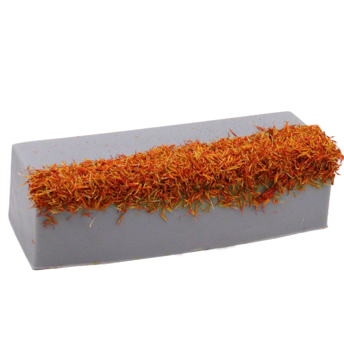 Coastal Wilderness soap loaf, long grey block topped with a dense strip of orange dried petals