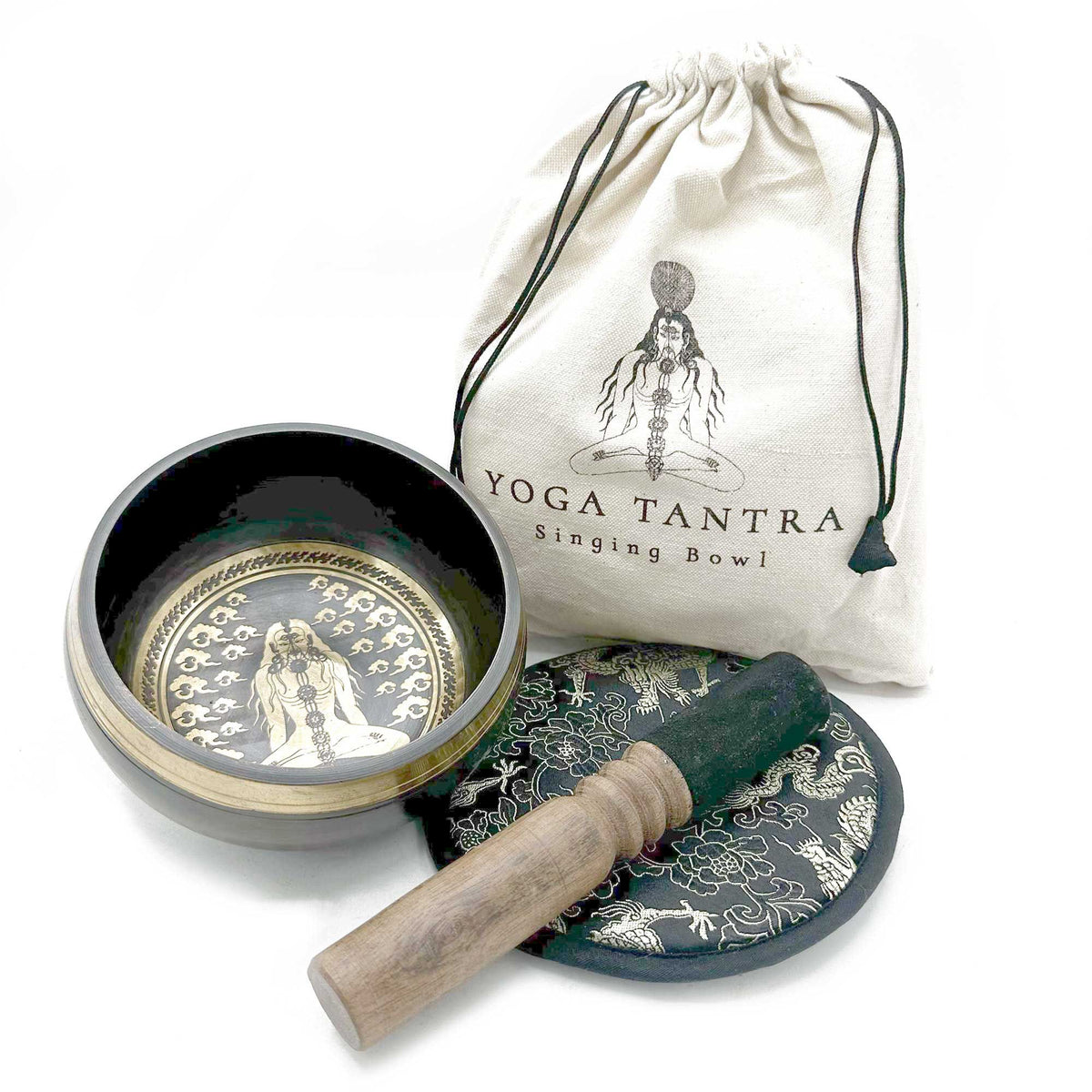 Hand Beaten & Engraved Singing Bowl Gift Set, 14cm, Yogi, bowl, striker and patterned cushion beside a drawstring bag