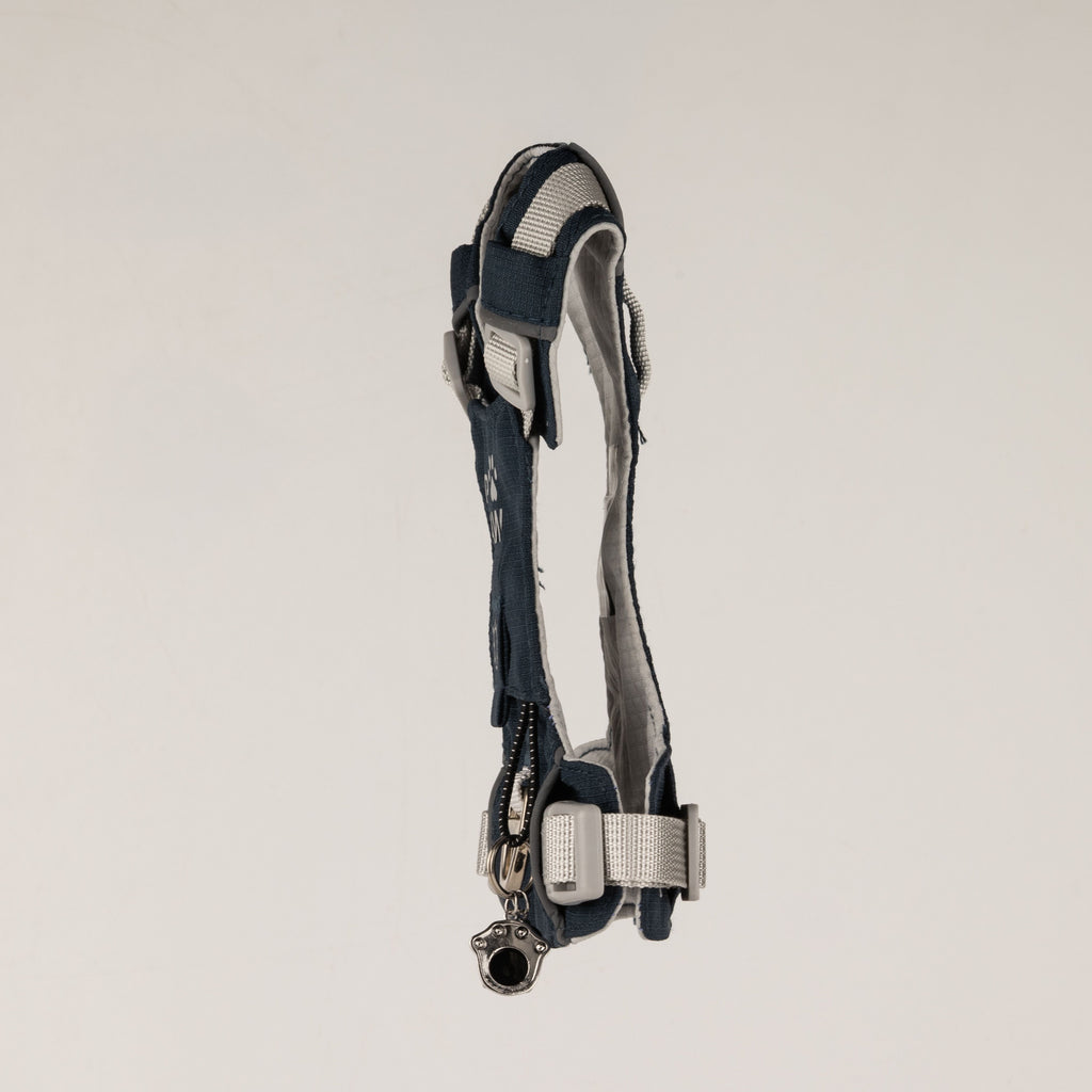 Side view of the PAW harness with its paw charm and adjustable straps