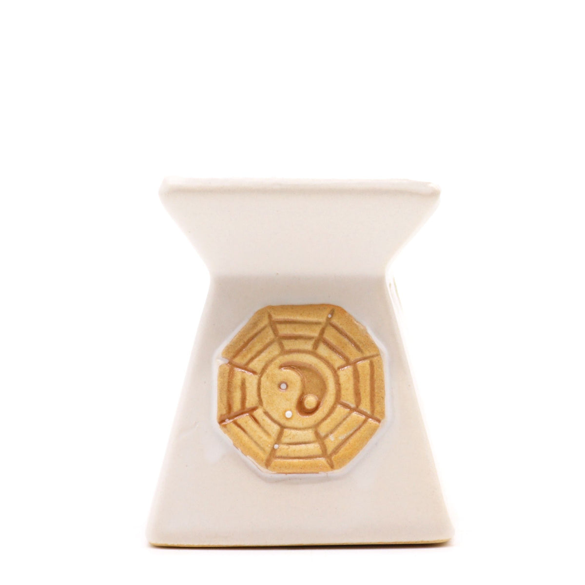 Cream ceramic oil burner with a yin yang medallion, tapered square shape