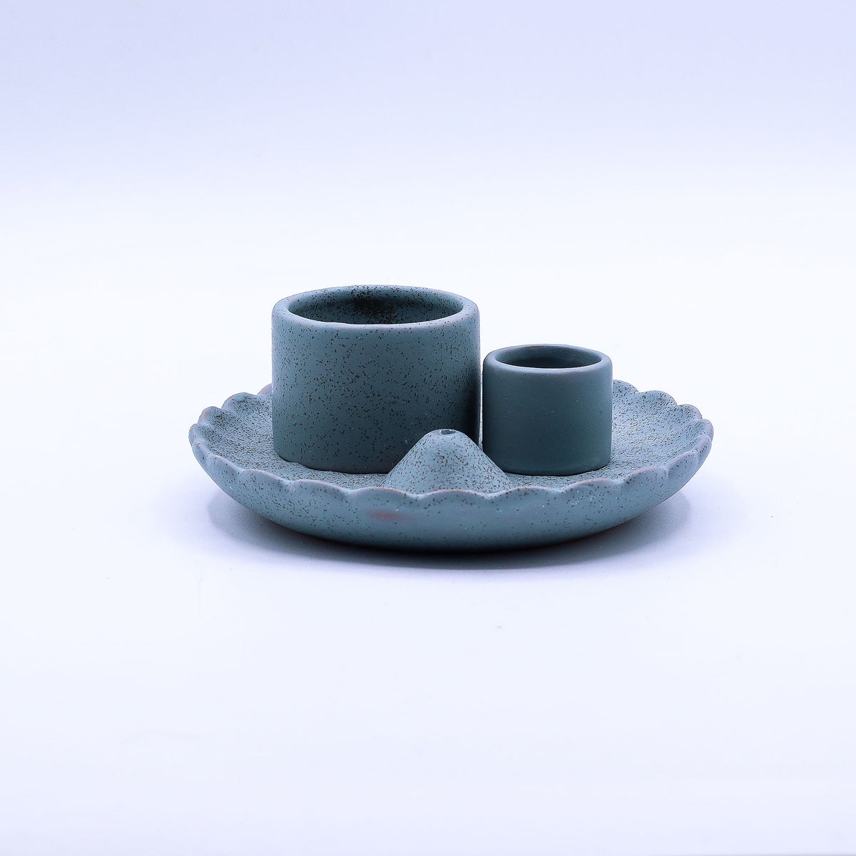 Blue lotus flower holder seen from the side, with two upright cylindrical holders on its scalloped dish
