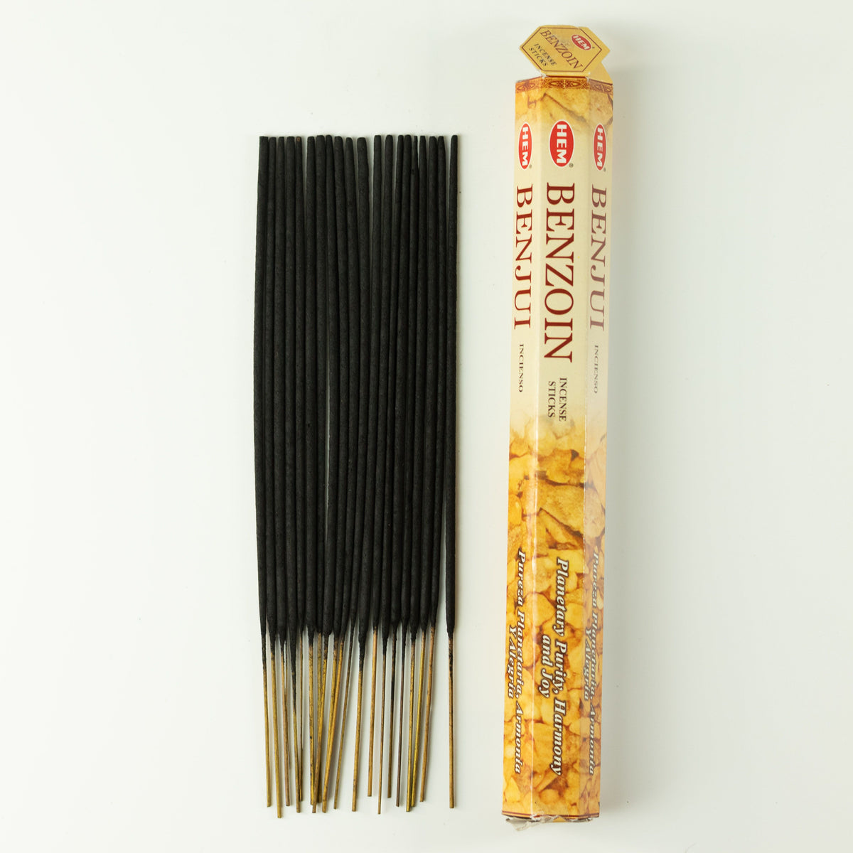 Loose incense sticks beside a HEM Benzoin pack