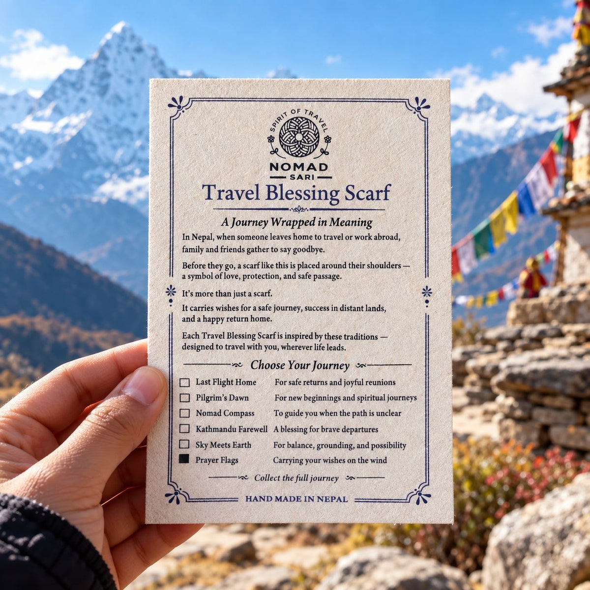 Printed Travel Blessing Scarf card held up against a mountain view