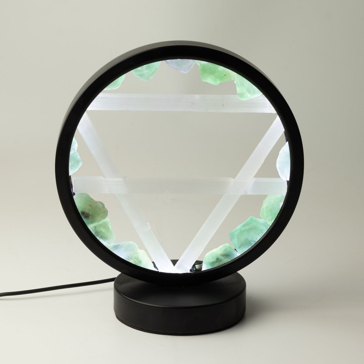 Earth gemstone halo lamp, illuminated with green stones around the circular frame