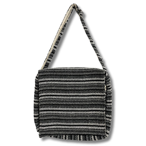 Grey and black striped laptop bag shown from the front with its long shoulder strap against white