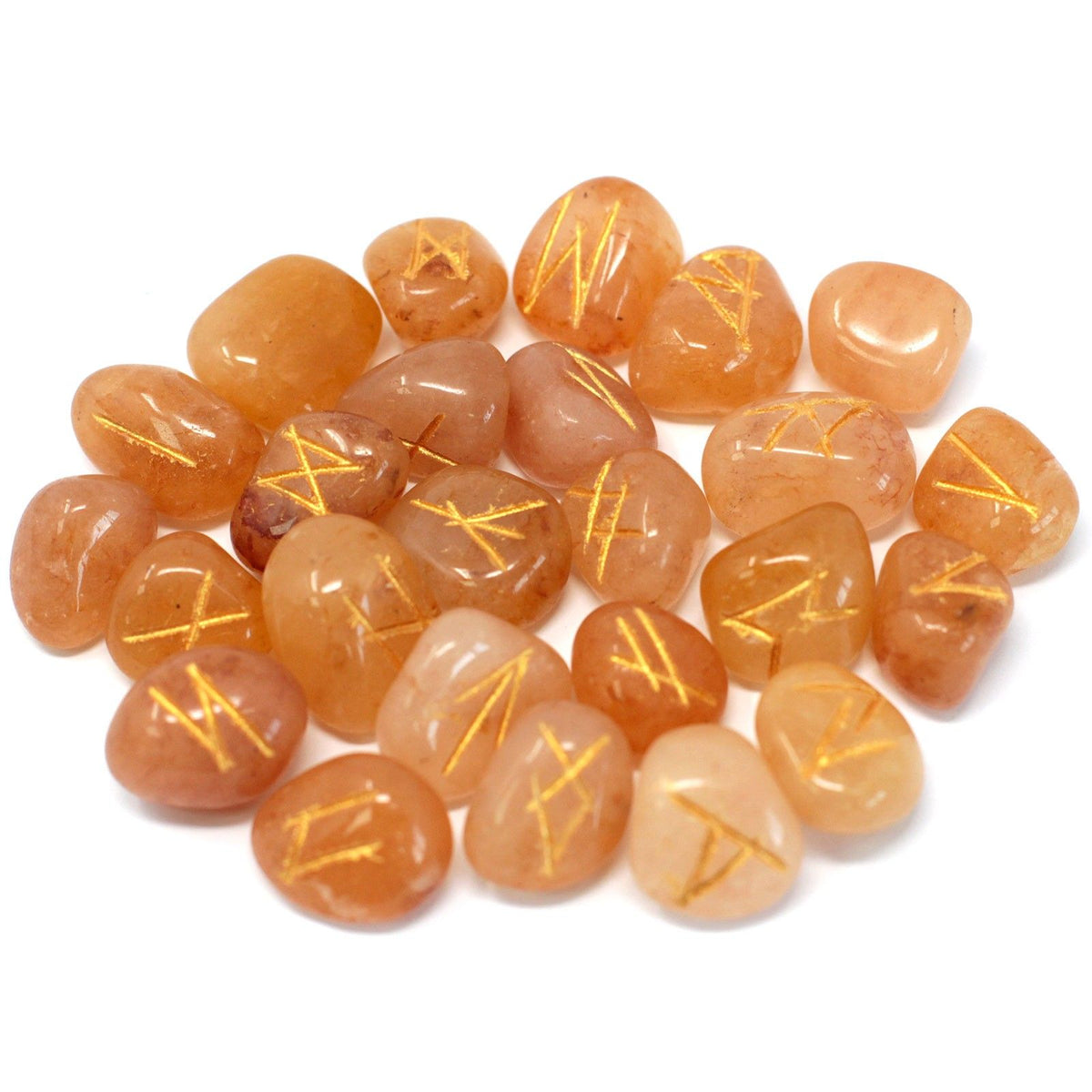 Yellow aventurine rune stones scattered on a white background, shown together from above