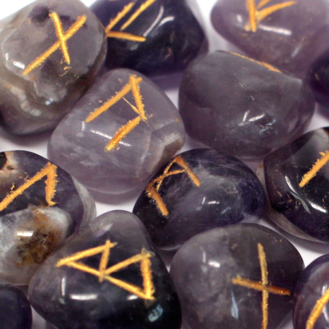 Runes Stone Set in Pouch, Amethyst, close-up of purple stones marked with gold runes