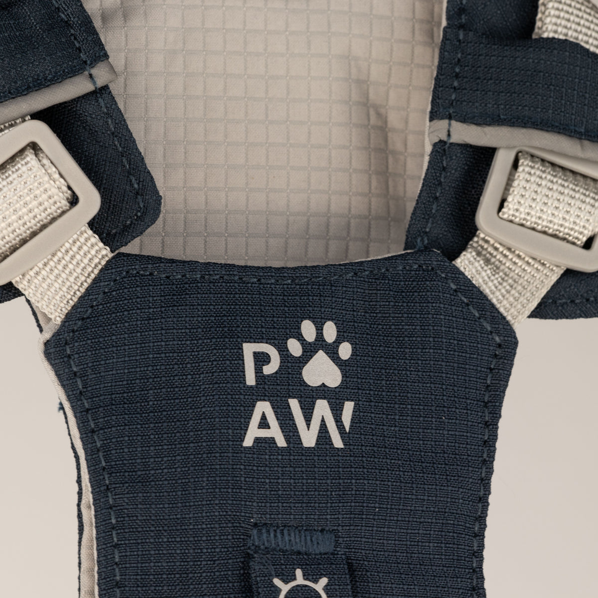 Close-up of the harness fabric and PAW logo