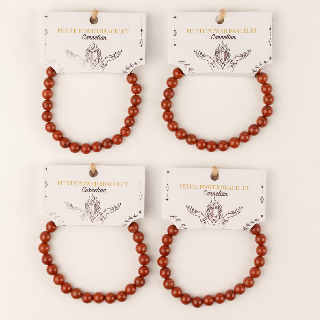 Several Carnelian bracelets displayed with presentation cards