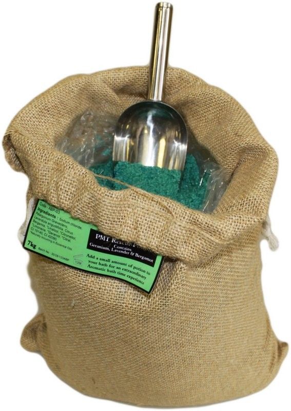 PMT Potion sack viewed from the front, filled with green bath salts and a metal scoop, label visible