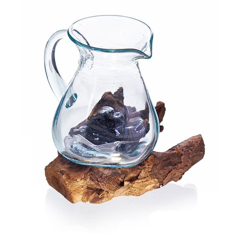Molten Glass on Wood- Water Jug, clear jug resting on a rough brown wood base against white