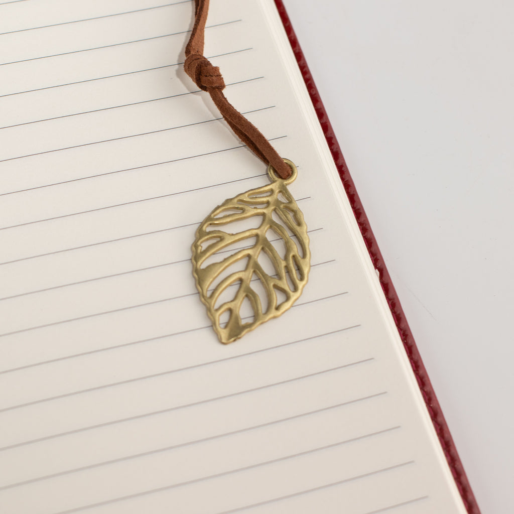 Close-up of the leaf-shaped bookmark on a lined page